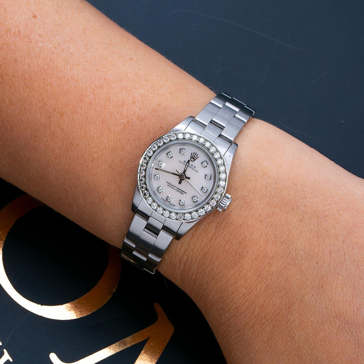 Pre-Owned Rolex Oyster Perpetual 26MM 76094 White Mother of Pearl Diamond Dial Diamond Bezel Stainless Steel Oyster Bracelet