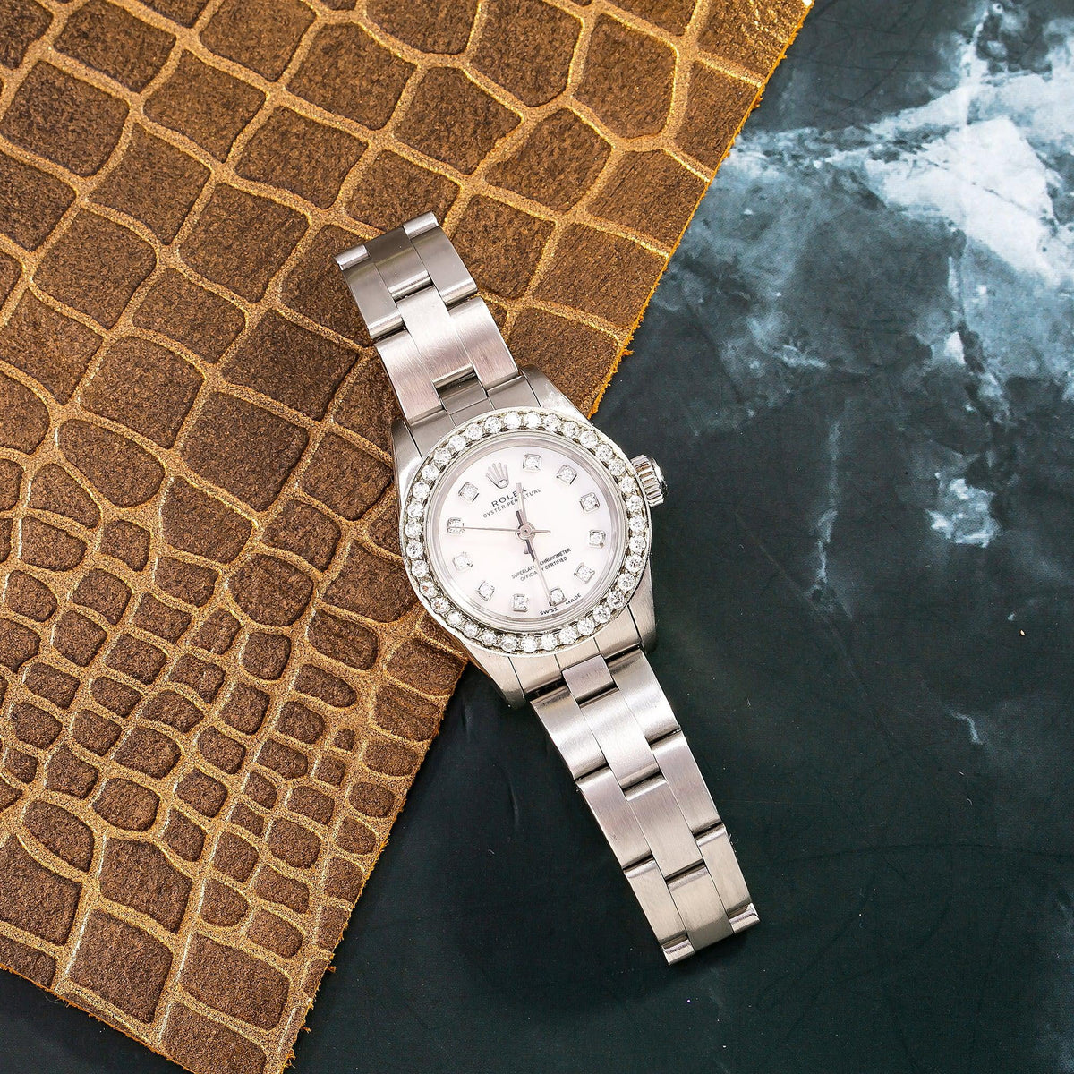 Pre-Owned Rolex Oyster Perpetual 26MM 76094 White Mother of Pearl Diamond Dial Diamond Bezel Stainless Steel Oyster Bracelet